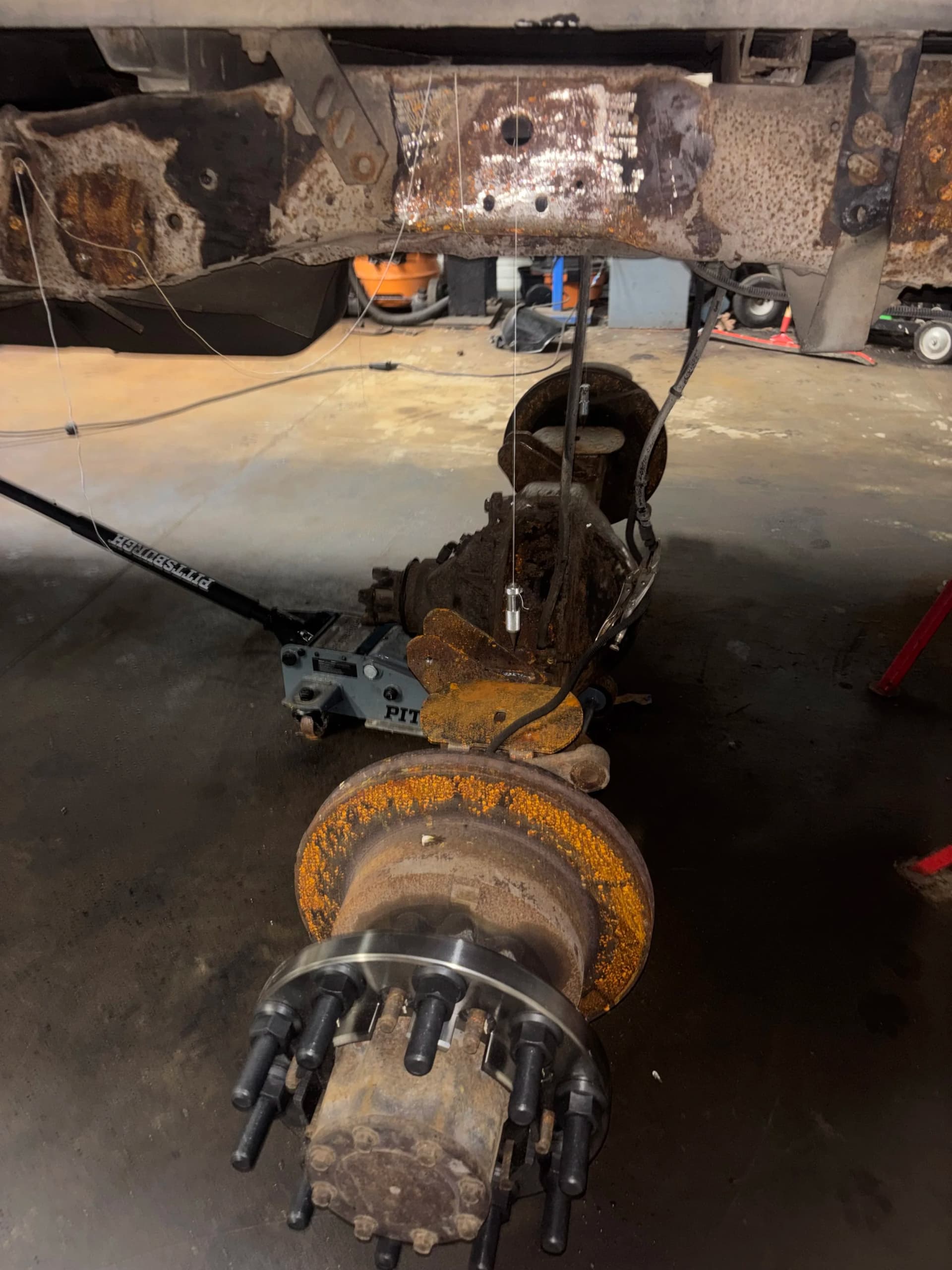 Ford F450 rear axle removed while the truck frame is prepared for custom suspension fabrication
